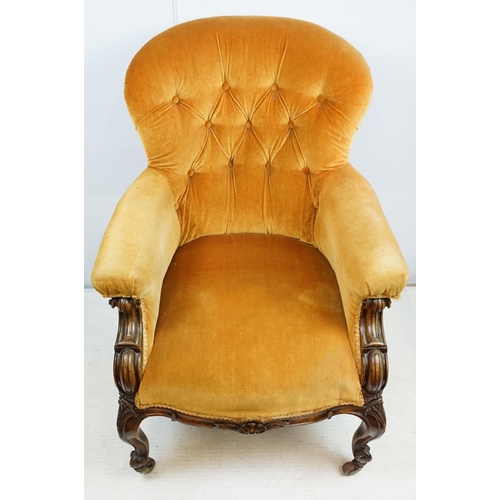 661 - Victorian mahogany carved armchair, upholstered in mustard with button back, on carved cabriole legs... 