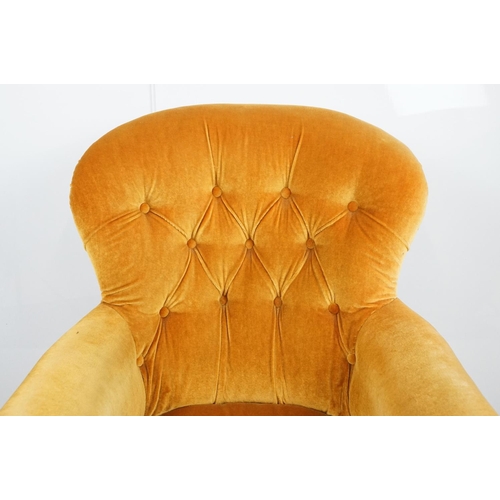 661 - Victorian mahogany carved armchair, upholstered in mustard with button back, on carved cabriole legs... 