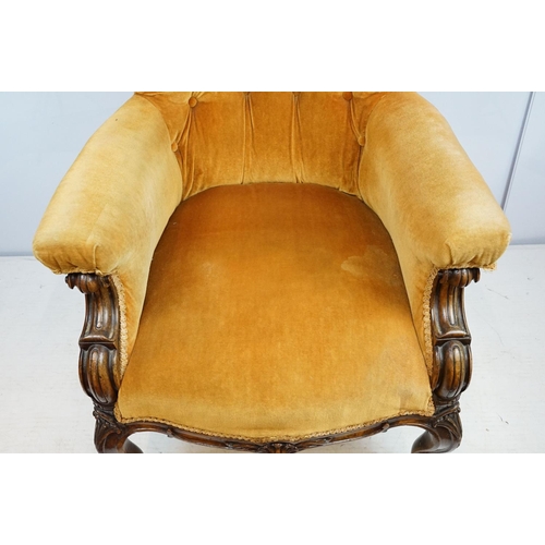 661 - Victorian mahogany carved armchair, upholstered in mustard with button back, on carved cabriole legs... 