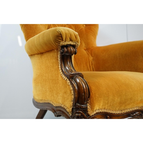 661 - Victorian mahogany carved armchair, upholstered in mustard with button back, on carved cabriole legs... 