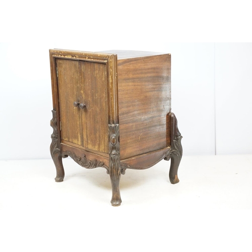 671 - Continental carved record storage cabinet, with ejector buttons, holding a number of 78s, 68cm high ... 