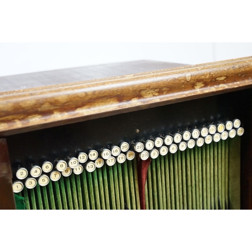 671 - Continental carved record storage cabinet, with ejector buttons, holding a number of 78s, 68cm high ... 