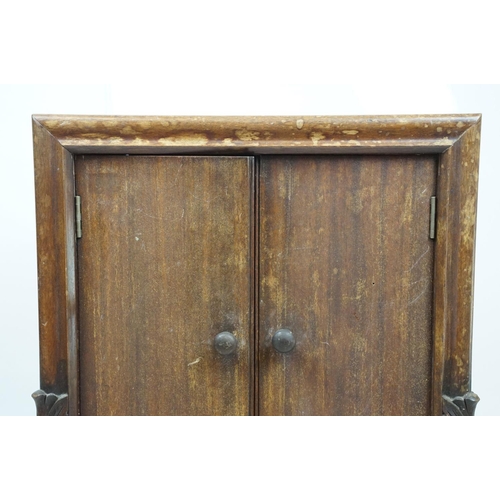 671 - Continental carved record storage cabinet, with ejector buttons, holding a number of 78s, 68cm high ... 