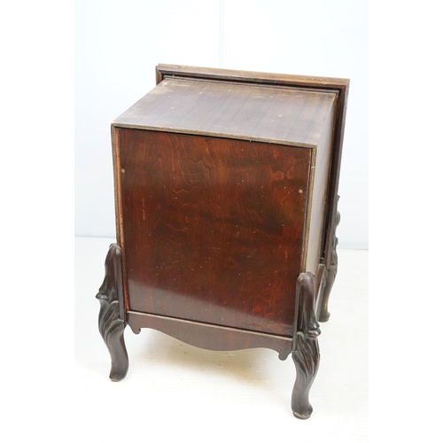 671 - Continental carved record storage cabinet, with ejector buttons, holding a number of 78s, 68cm high ... 