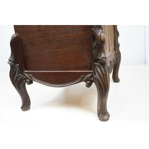 671 - Continental carved record storage cabinet, with ejector buttons, holding a number of 78s, 68cm high ... 