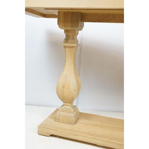 675 - John Lewis pale oak console table of rectangular form over two baluster supports and plinth base, 75... 