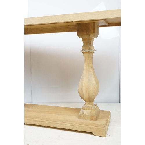 675 - John Lewis pale oak console table of rectangular form over two baluster supports and plinth base, 75... 