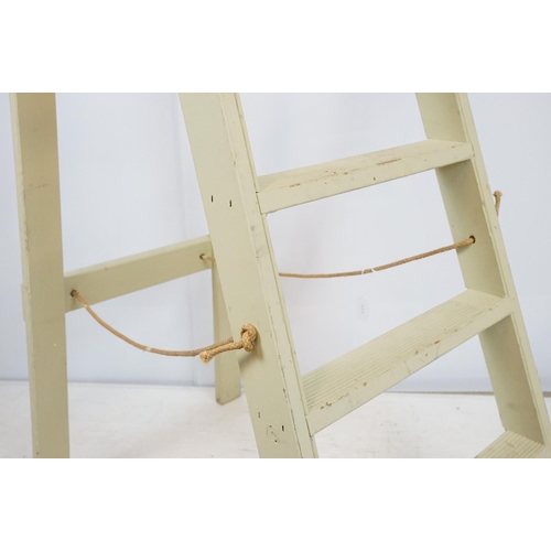 679 - Green painted decorative ladder with seven steps, 174cm high