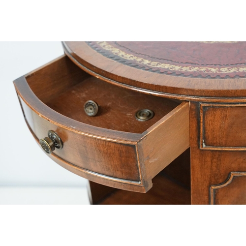 690 - Early 20th century mahogany revolving drum bookcase, with red leather gilt embossed top, with three ... 