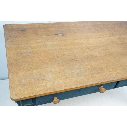 692 - Oak kitchen table with two drawers, the base painted in blue, on carved legs, 72cm high x 134cm wide... 