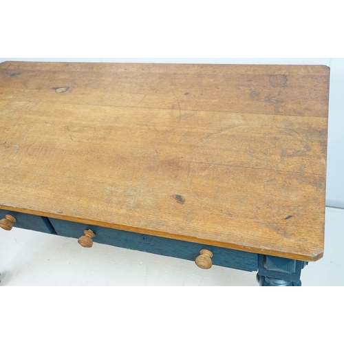 692 - Oak kitchen table with two drawers, the base painted in blue, on carved legs, 72cm high x 134cm wide... 