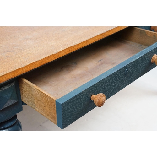 692 - Oak kitchen table with two drawers, the base painted in blue, on carved legs, 72cm high x 134cm wide... 