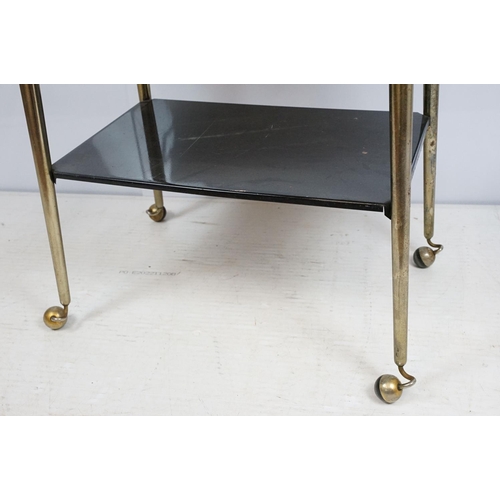 694 - Mid century black and gold two tier trolley table , 70cm high x 81cm wide x 40cm deep