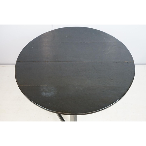 700 - Carved oak drop leaf table, black painted, 58cm high x 67cm diameter