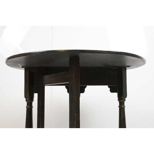 700 - Carved oak drop leaf table, black painted, 58cm high x 67cm diameter