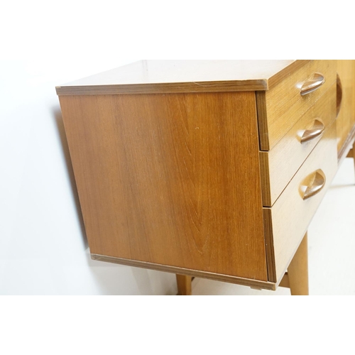 712 - Avalon teak sideboard with an arrangement of three drawers and two sliding cupboard doors, maker's l... 