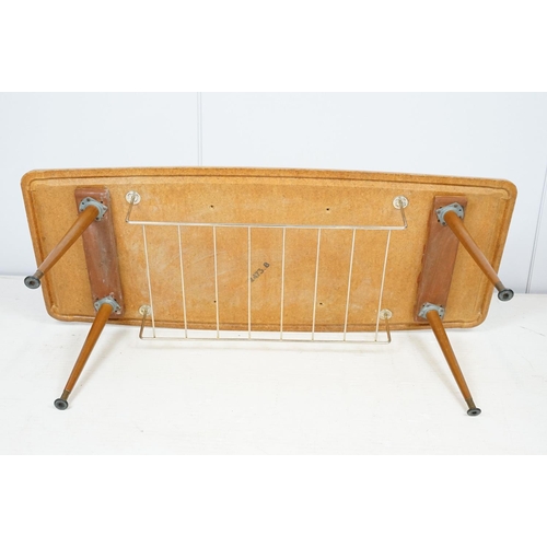 743 - Mid century coffee table with rack to underside on tapering legs with metal feet, 35cm high x 107cm ... 