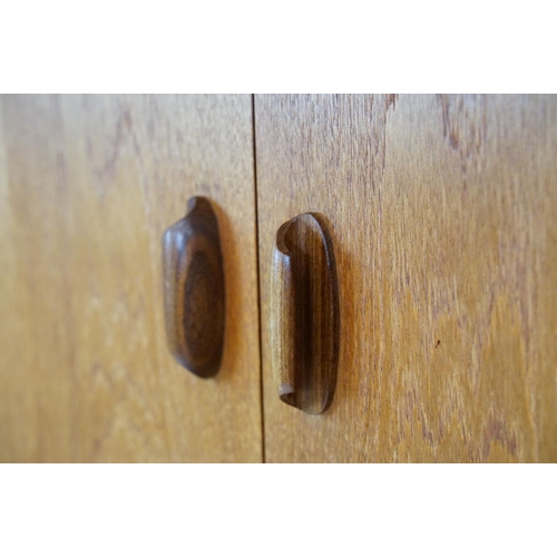 745 - G Plan teak sideboard, with cupboards above two long drawers and a further cupboard, with maker's la... 