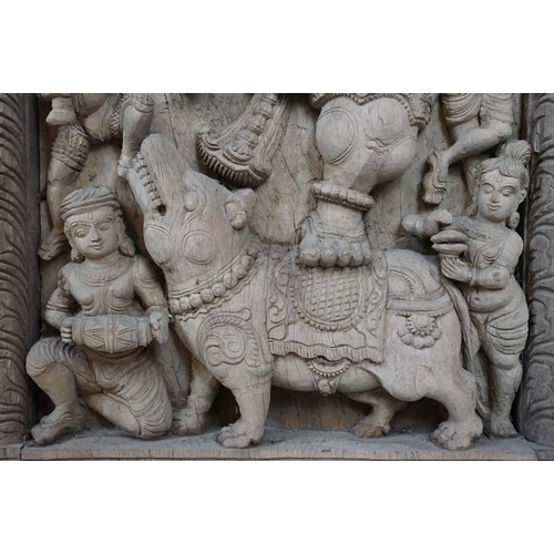 755 - Pair of large Indian carved wooden panels depicting Ganesh surrounded by various figures, each measu... 