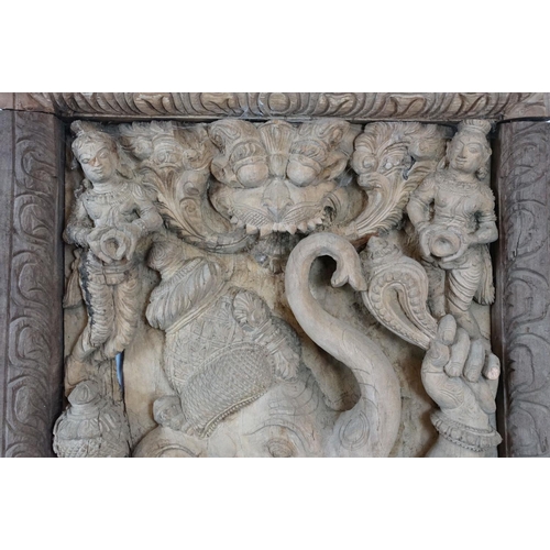 755 - Pair of large Indian carved wooden panels depicting Ganesh surrounded by various figures, each measu... 