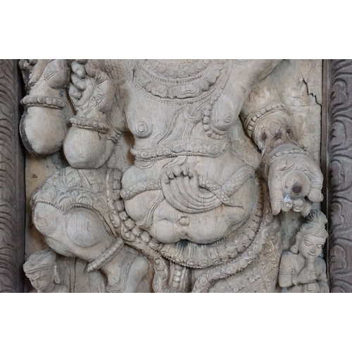 755 - Pair of large Indian carved wooden panels depicting Ganesh surrounded by various figures, each measu... 