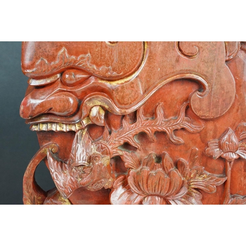 165 - Chinese red lacquered carved wooden sculpture depicting a grotesque mask, bird & flower, approx 43cm... 