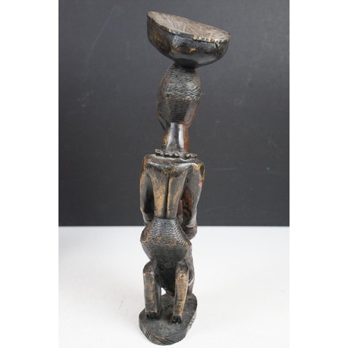 166 - Pair of African carved hardwood stylised figures, tallest approx 34cm