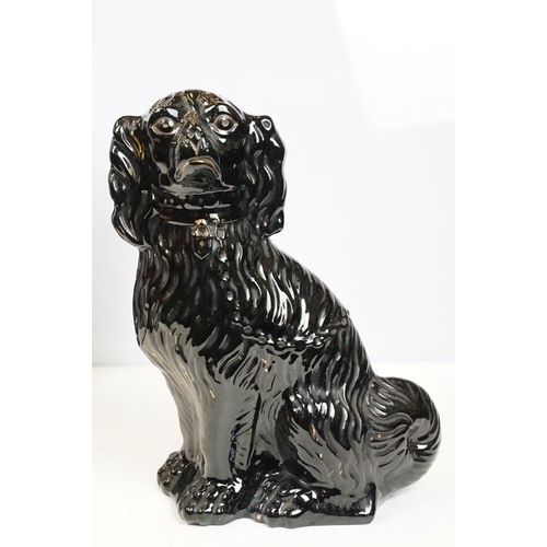 20 - Pair of black dogs in Staffordshire style, 35cm high