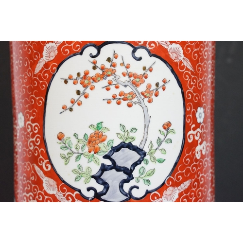 21 - Chinese porcelain stick stand decorated in enamels with panels of blossom trees on a red ground with... 