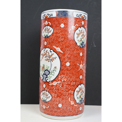 21 - Chinese porcelain stick stand decorated in enamels with panels of blossom trees on a red ground with... 