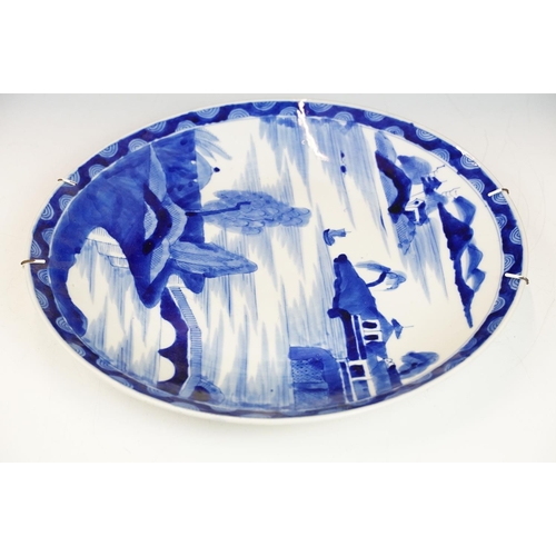 62 - Chinese blue & white charger decorated with a scene with boat and mountains beyond, approx 40cm diam... 