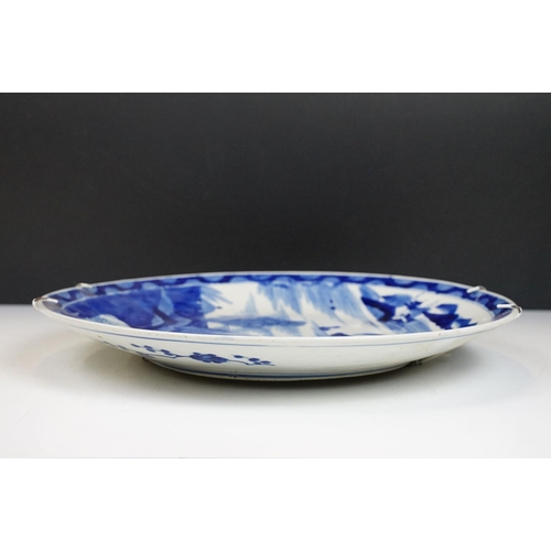 62 - Chinese blue & white charger decorated with a scene with boat and mountains beyond, approx 40cm diam... 