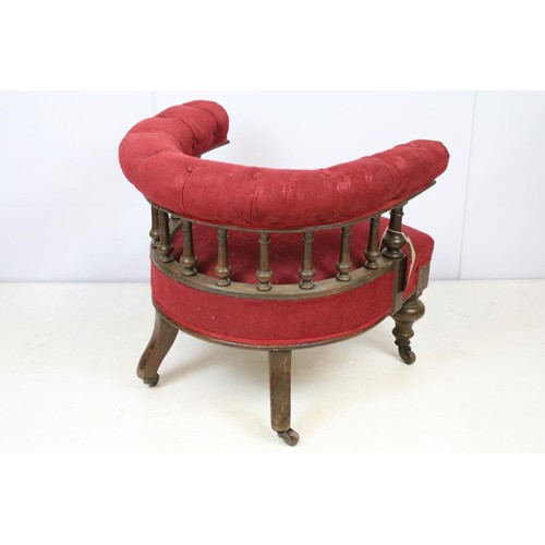 651 - Early 20th century oak framed tub armchair with button back above galleried turned supports, on turn... 