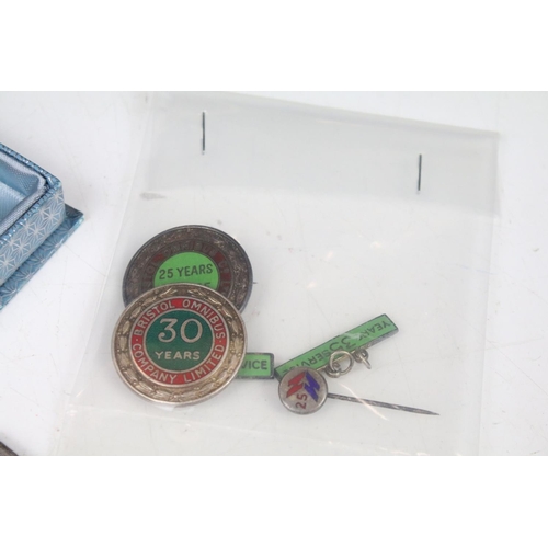 215 - A group of Bristol Bus collectables to include badges, Medals and ephemera all related to the same p... 