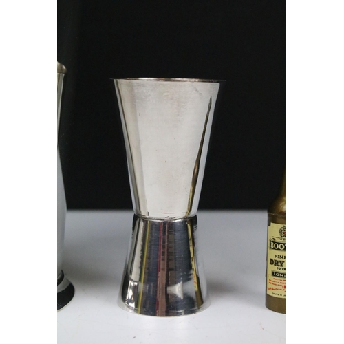 216 - An early to mid 20th century silver plated cocktail shaker together with measuring cup and a set of ... 