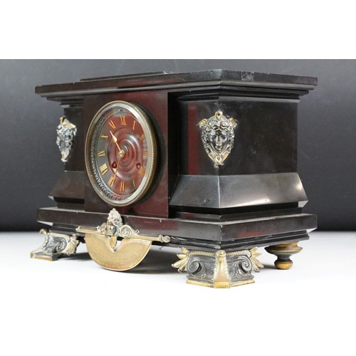 143 - Victorian slate mantel clock the dial with brass roman numerals, the case with classical masks and b... 