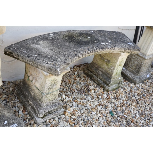 622 - Stone garden seat of curved form, raised on two supports with floral decoration in relief, approx 11... 