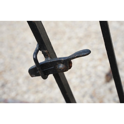 624 - Black painted wrought iron driveway gate (approx 292cm wide), together with a metal garden gate