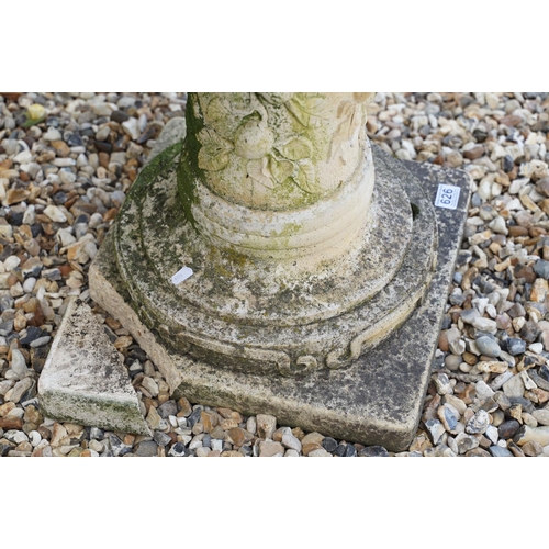 626 - Reconstituted stone round top garden table with metal plaque to centre, raised upon a support with r... 