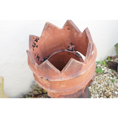 630 - Terracotta chimney pot of cylindrical form (approx 78cm high, a/f), together with a further chimney ... 