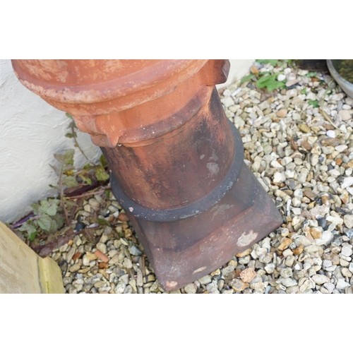 630 - Terracotta chimney pot of cylindrical form (approx 78cm high, a/f), together with a further chimney ... 