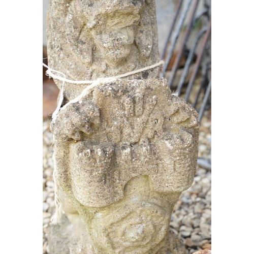 633 - Reconstituted stone garden sculpture in the form of a rampant lion holding a shield, approx 63cm hig... 