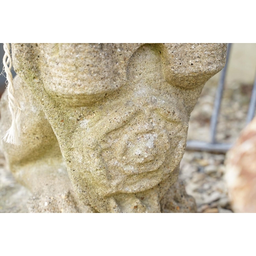 633 - Reconstituted stone garden sculpture in the form of a rampant lion holding a shield, approx 63cm hig... 