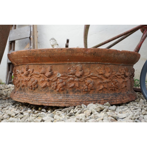 636 - Terracotta circular garden planter with grapevine decoration (approx 66cm diameter, a/f), together w... 