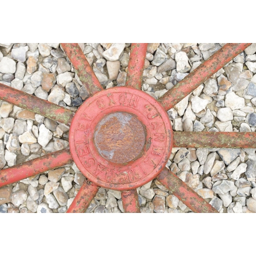 637 - Pair of Jarmain Haseley spoked iron red painted iron cart wheels, approx 111cm diameter