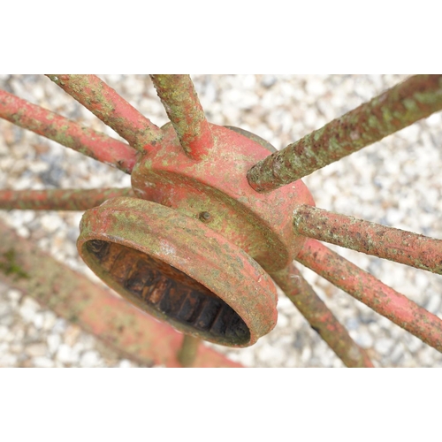 637 - Pair of Jarmain Haseley spoked iron red painted iron cart wheels, approx 111cm diameter