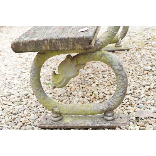 640 - Garden bench with wooden seat & back rest, raised upon two cast iron supports in the form of dragons... 