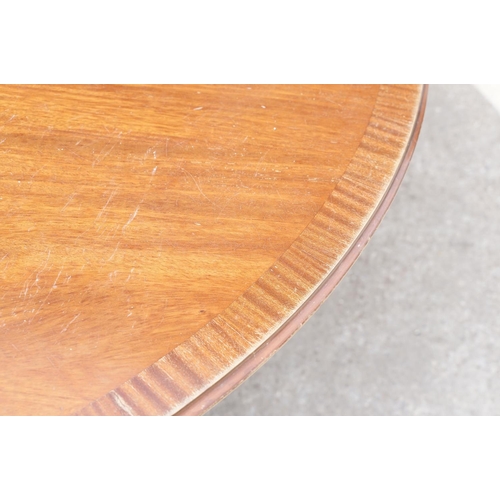 644 - Large circular mahogany dining table with veneer to edge, raised on a five-footed base with casters,... 