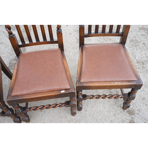 647 - Set of four oak dining chairs with barley twist supports and carved crown details to backs, with lea... 