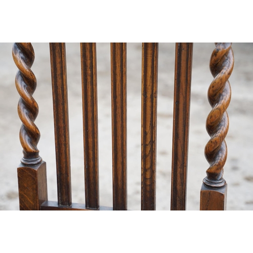 647 - Set of four oak dining chairs with barley twist supports and carved crown details to backs, with lea... 